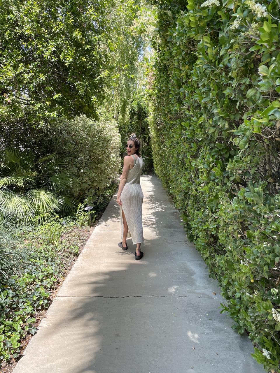 Lara, the author, walking along the concrete path that connects the hotel's grounds