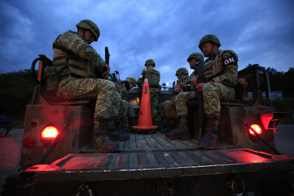 Soldiers forming part of Mexico's National Guard board a truck to patrol back roads used to circumvent a migration checkpoint, in Comitan, Chiapas state, Mexico, Saturday, June 15, 2019. Under pressure from the U.S. to slow the flow of migrants north, Mexico plans to deploy thousands of National Guard troops by Tuesday to its southern border region. (AP Photo/Rebecca Blackwell)