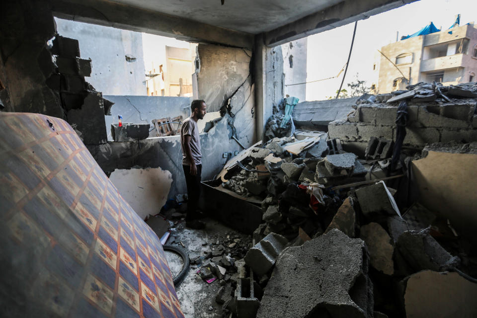 People search through the rubble of a bombed-out building in Khan Younis, Gaza, on Monday. 