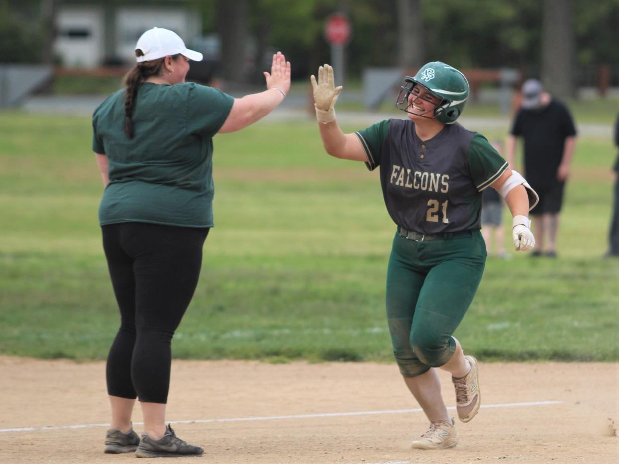 Dighton-Rehoboth's Haleigh Kelley hi-fives coach Katie Holmes as she rounds third after hitting a home run during a South Coast Conference game against Apponequet on May 15, 2023.