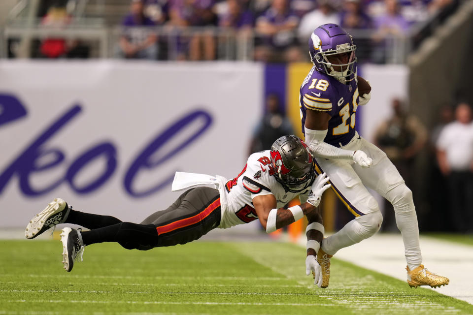 Minnesota Vikings wide receiver Justin Jefferson (18) runs from Tampa Bay Buccaneers cornerback Carlton Davis III (24) after catching a pass during the first half of an NFL football game, Sunday, Sept. 10, 2023, in Minneapolis. (AP Photo/Abbie Parr)