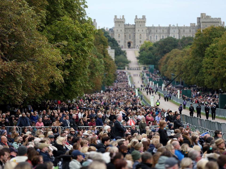 People gather on the long walk outside of Windsor Castle during Queen Elizabeth's funeral.