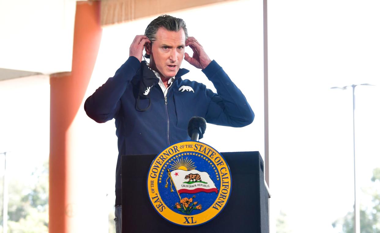 California Governor Gavin Newsom arrives to brief the media on the opening day of a new mass Covid-19 vaccination site established between the federal government and the state on February 16, 2021 on the campus at California State University of Los Angeles in Los Angeles, California. - The CSULA site, along with a similar site at the Oakland-Alameda Coliseum, will be co-run by the Federal Emergency Management Agency and the state of California through the governor's Office of Emergency Services and is expected to have an ultimate capacity of administering 6,000 doses per day in the fight against the coronavirus pandemic. (Photo by Frederic J. BROWN / AFP) (Photo by FREDERIC J. BROWN/AFP via Getty Images)