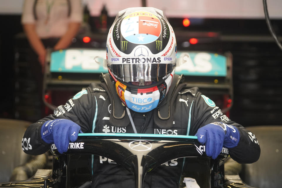 Mercedes driver Valtteri Bottas, of Finland, climbs out of his car following a practice session for the F1 US Grand Prix auto race at the Circuit of the Americas, Friday, Oct. 22, 2021, in Austin, Texas. (AP Photo/Darron Cummings)