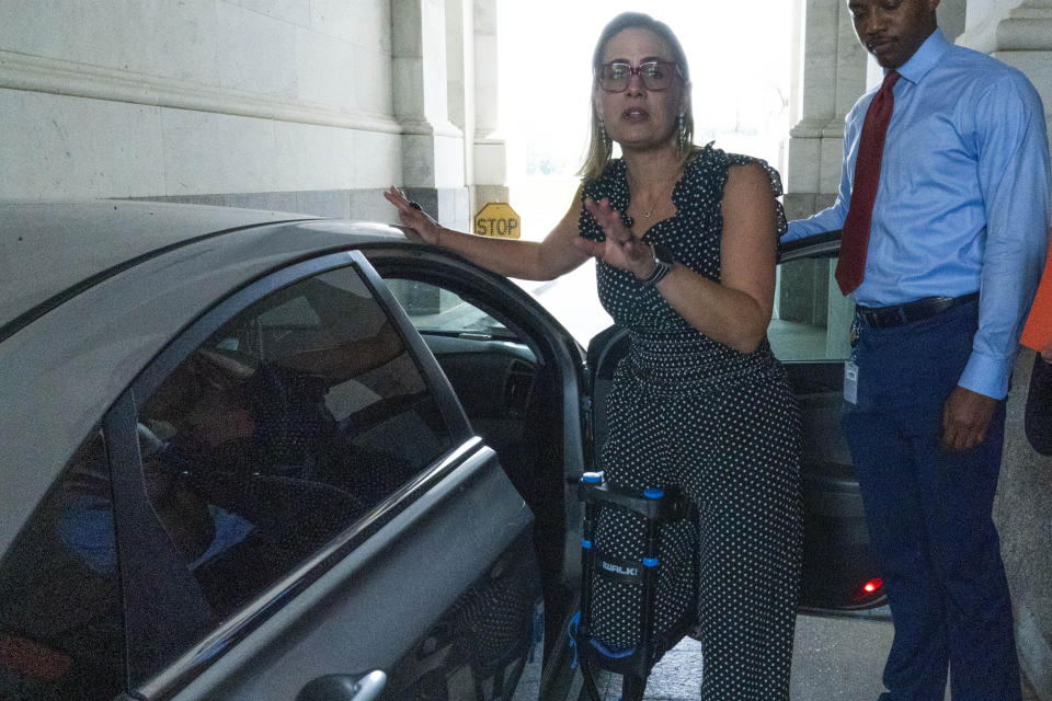 Sen. Kyrsten Sinema, D-Ariz., leaves, after a closed door talks about infrastructure on Capitol Hill in Washington Thursday, July 15, 2021. (AP Photo/Jose Luis Magana)
