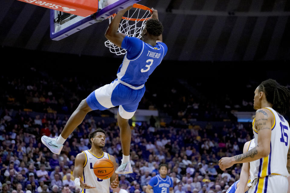 Kentucky guard Adou Thiero (3) dunks next to LSU guard Jordan Wright during the first half of an NCAA college basketball game in Baton Rouge, La., Wednesday, Feb. 21, 2024. (AP Photo/Matthew Hinton)