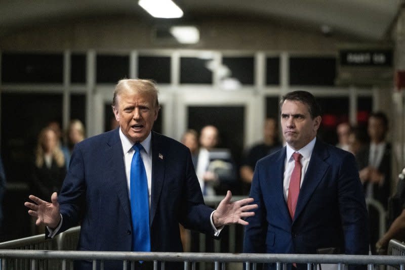 Former President Donald Trump speaks to the media as his attorney Todd Blanche (R) listens while leaving his criminal trial at Manhattan Criminal Court in New York on Monday. Trump is charged with falsifying business records to cover up a sex scandal during the 2016 campaign. Pool photo by Victor J. Blue/UPI