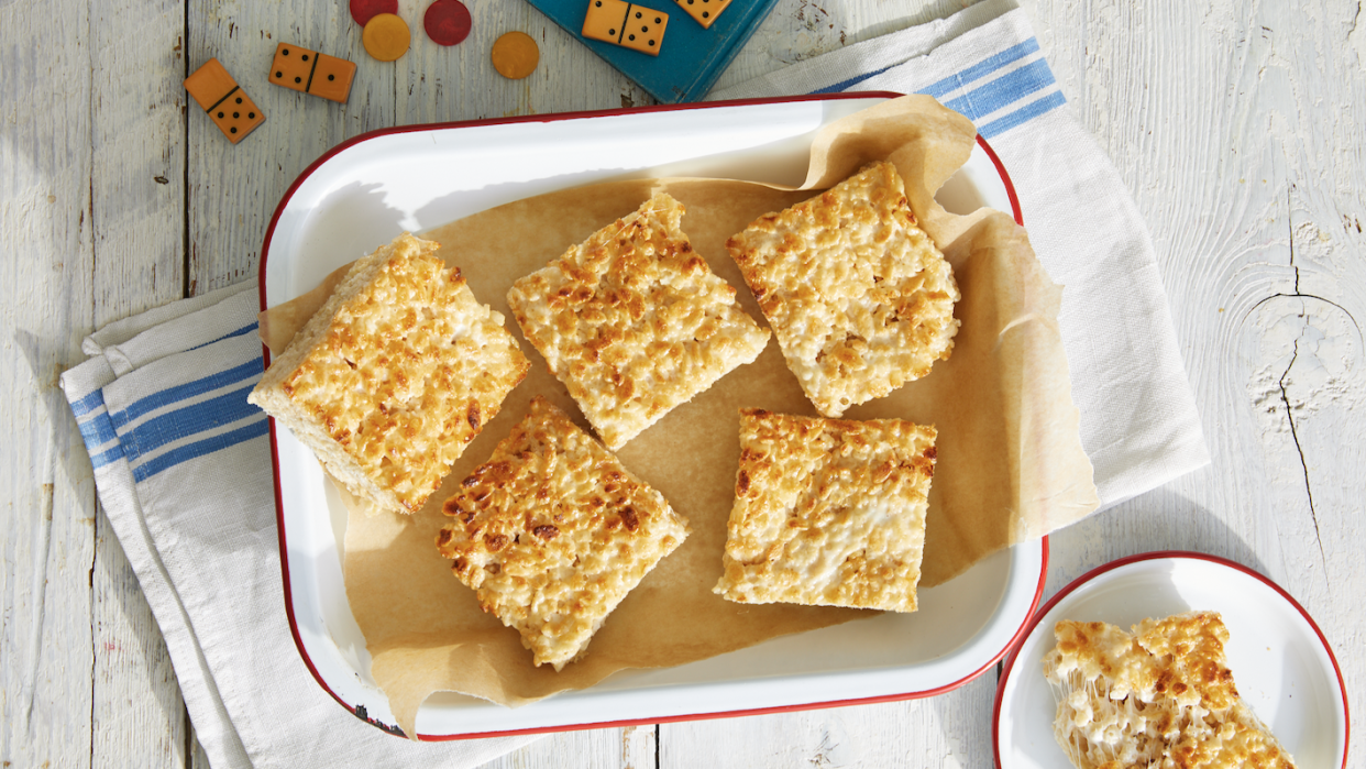 caramelized rice krispie treats in an enamelware dish