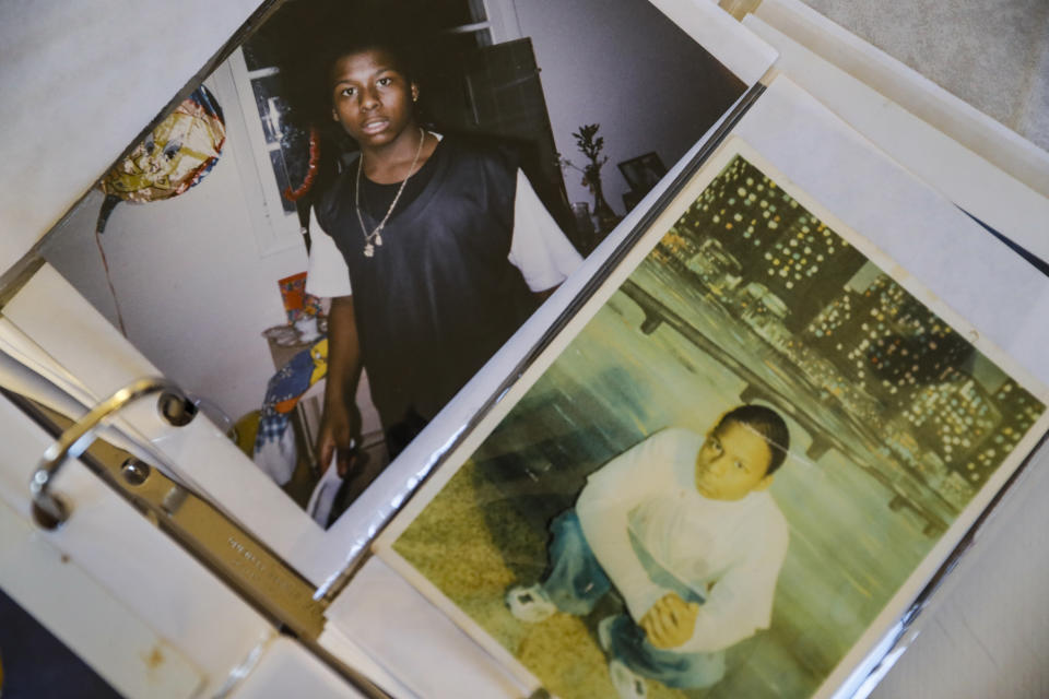 In this Oct. 25, 2019, photo, family photos of Myon Burrell during his teenage years before and after incarceration are shown by his sister Ianna at her home in Shakopee, Minn. Sentenced to life after a young black girl was killed by a stray bullet, Burrell's story has been told - and told again - by U.S. Sen. Amy Klobuchar while trumpeting her tough-on-crime record as a top Minneapolis prosecutor. But a year-long Associated Press investigation discovered major flaws and inconsistencies in the case, raising questions about whether the 16-year-old alleged shooter may have been wrongly convicted. (AP Photo/John Minchillo)