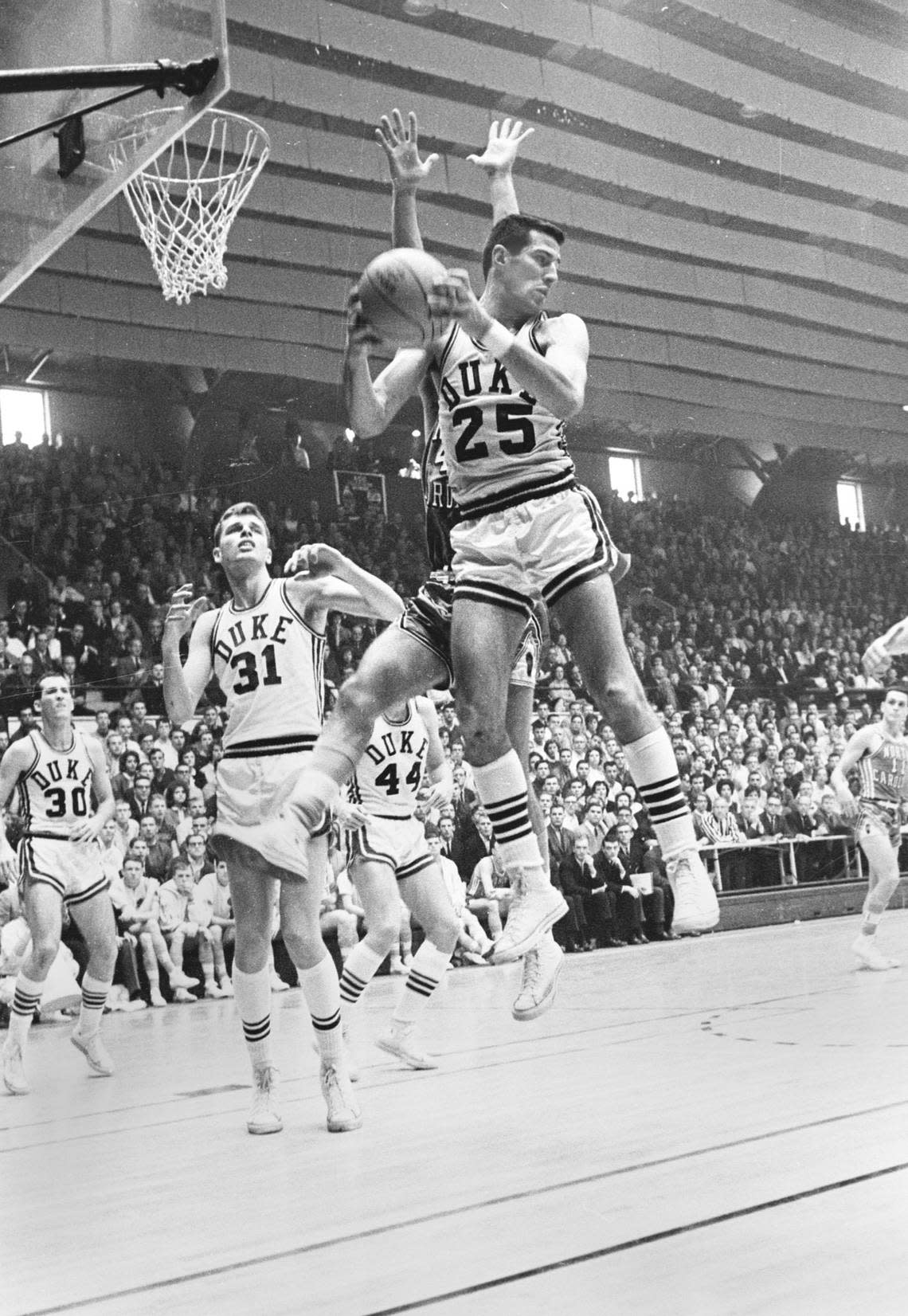 Duke’s Art Heyman (25) rebounds ball during his last game played in Cameron Indoor Stadium on February 23,1963.