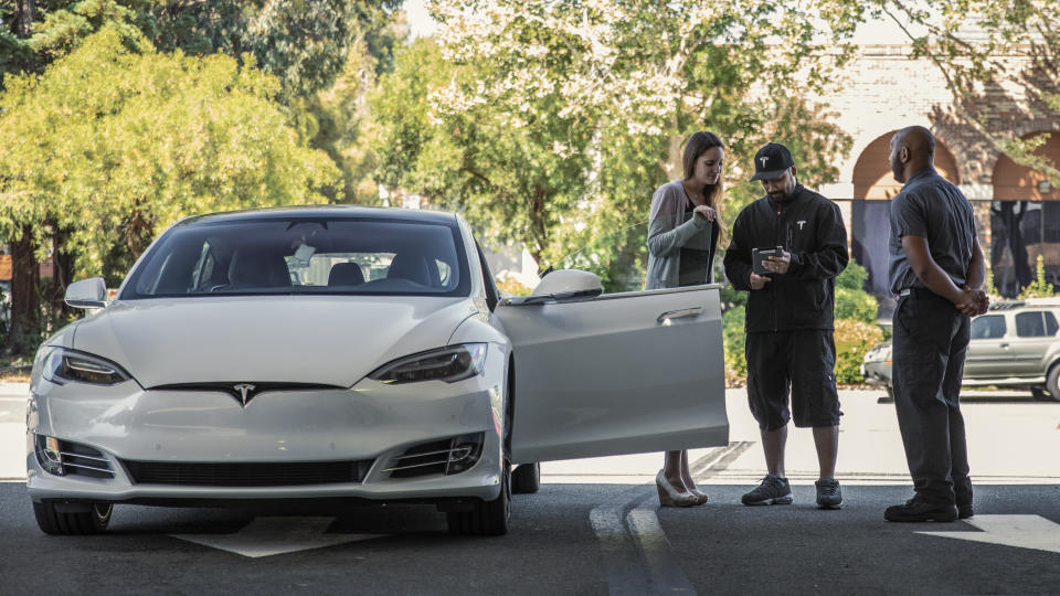 A woman taking a test drive in a Model S