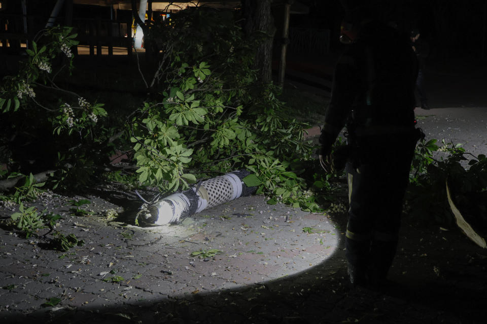 REMOVES ATTRIBUTION THAT THIS WAS A RUSSIAN ROCKET Police officers investigate fragments of a rocket that fell down in a city zoo after it was shot down by air defense system during the night in Kyiv, Ukraine, early Tuesday, May 16, 2023. (AP Photo/Alex Babenko)