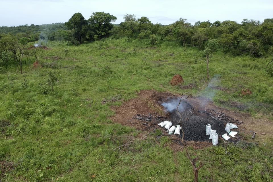 Smoke rises from a pile of charcoal burning in Gulu, Uganda, May 27, 2023. Uganda's population explosion has heightened the need for cheap plant-based energy sources, especially charcoal. (AP Photo/Patrick Onen)