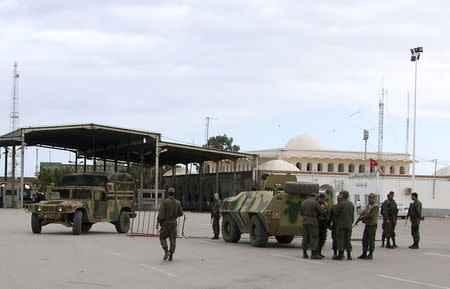 File photo of Tunisian soldiers standing guard at the border crossing at Ras Jdir Ben Guerdane, in this picture taken December 5, 2014. REUTERS/Stringer/Files