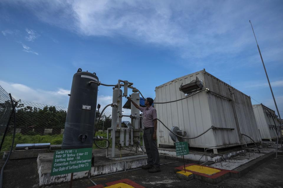 An officer checks a part of a hydrogen plant at Oil India Limited in Jorhat, India, Thursday, Aug. 17, 2023. Green hydrogen is being touted around the world as a clean energy solution to take the carbon out of high-emitting sectors like transport and industrial manufacturing. (AP Photo/Anupam Nath)