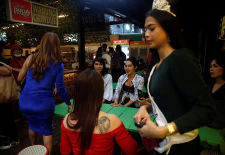 A group of Indonesian transvestites spend their time at a cafe in Jakarta, Indonesia, February 8, 2018. Picture taken February 8, 2018. REUTERS/Beawiharta