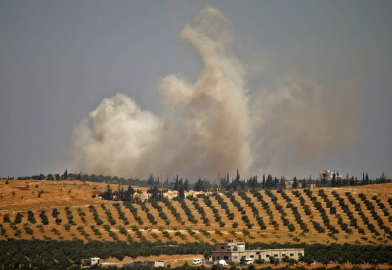 Smoke rises above a rebel-held area of Daraa province following a Syrian government air strike on June 25, 2018