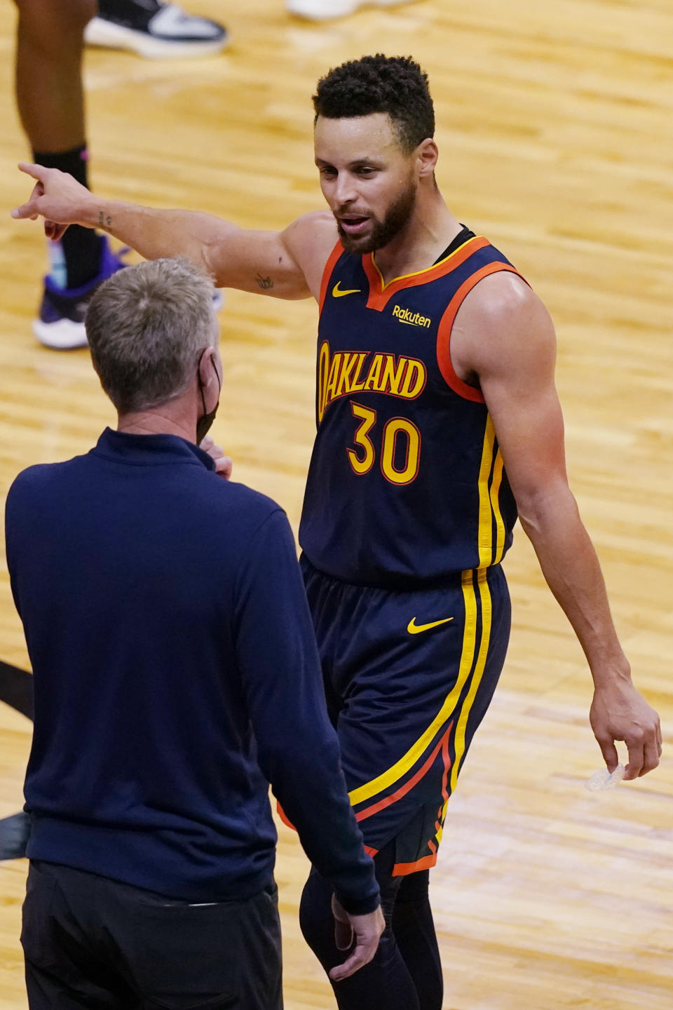 Golden State Warriors guard Stephen Curry (30) talks to head coach Steve Kerr during the second half of an NBA basketball game against the Miami Heat, Thursday, April 1, 2021, in Miami. (AP Photo/Marta Lavandier)