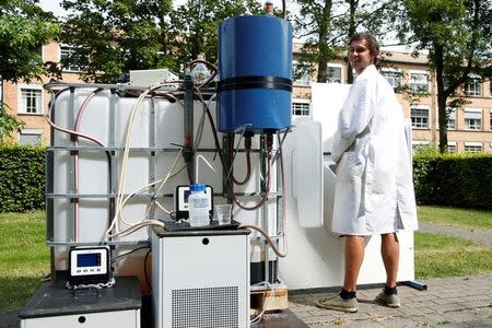 Belgian scientist Sebastiaan Derese poses with a machine that turns urine into drinkable water and fertilizer using solar energy, at the University of Ghent, Belgium, July 26, 2016. REUTERS/Francois Lenoir