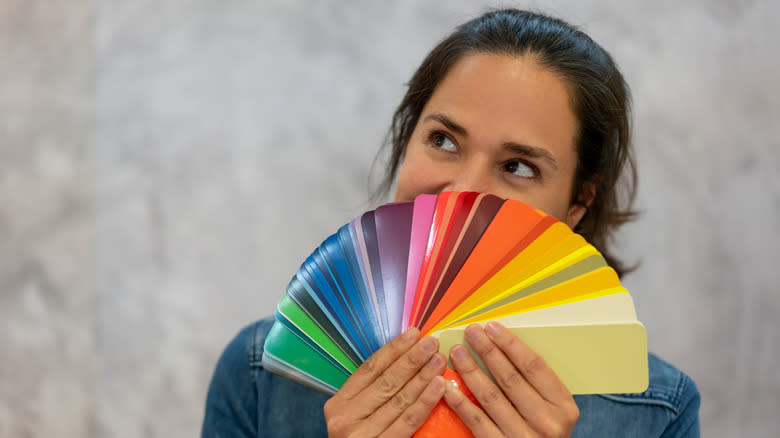 woman holding colorful swatches