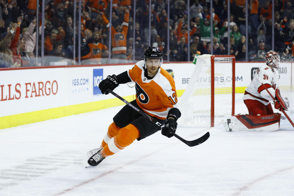 Philadelphia Flyers' Michael Raffl (12) skates past Carolina Hurricanes' Alex Nedeljkovic (39) after scoring a goal during the second period of an NHL hockey game, Thursday, March 5, 2020, in Philadelphia. (AP Photo/Matt Slocum)