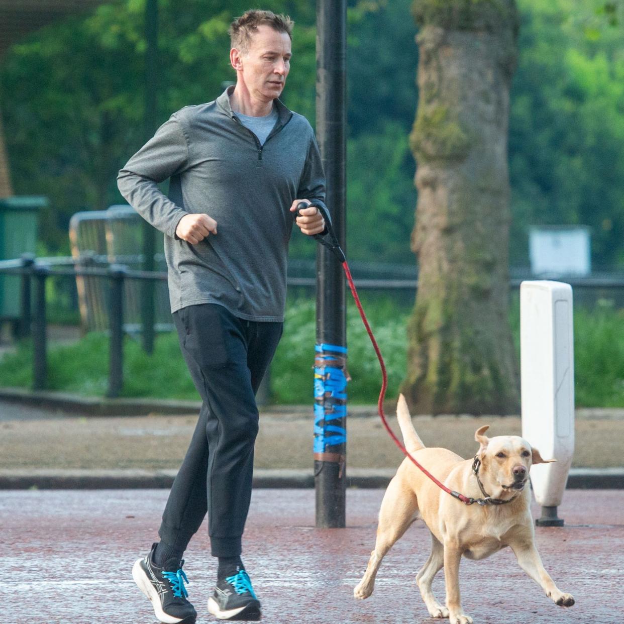 Jeremy Hunt, the Chancellor, is pictured in Westminster this morning going for a run with his dog Poppy