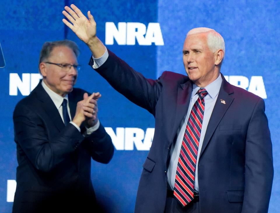 NRA Executive Vice President and CEO Wayne LaPierre applauds as former Vice President and Indiana Govorner Mike Pence takes the stage Friday, April 14, 2023, during the NRA convention at the Indiana Convention Center in Indianapolis