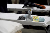 a sleeping area set up inside exhibit hall B of the Long Beach Convention Center, Thursday, April 22, 2021, in Long Beach, Calif., where migrant children found at the U.S.-Mexico border without a parent will be temporarily housed. The beds are in pods of 30. The center is able to house up to 1,000 children and the first children are expected to arrive Thursday afternoon. (Brittany Murray/The Orange County Register via AP, Pool)