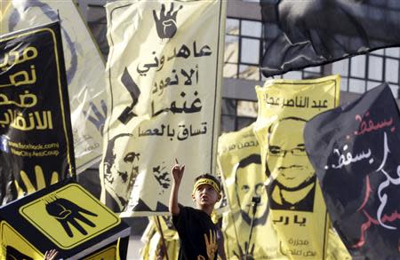 A boy, with supporters of the Muslim Brotherhood and ousted Egyptian President Mohamed Mursi, shouts slogans and gestures during a protest near Rabaa al-Adaweya square in Cairo, October 4, 2013. REUTERS/Amr Abdallah Dalsh