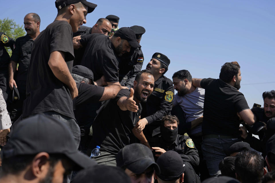 Iraqi security forces prevent protesters from entering the Federal Court during a demonstration in Baghdad, Iraq, Monday, Aug. 29, 2022. (AP Photo/Hadi Mizban)