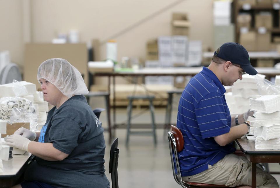 Associates Michelle Marley and Seth Weber work Aug. 24 at Lakeside Packaging Plus in Neenah.