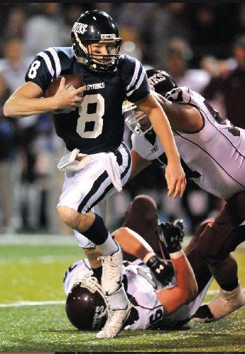 Bartlesville High quarterback Kirby Schoenthaler scrambles away from Jenks High players during a 2009 shootout at Custer Stadium. Schoenthaler would play four years at Dartmouth.