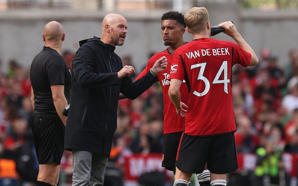 Erik ten Hag issues instructions to Jadon Sancho and Donny van de Beek on the touchline