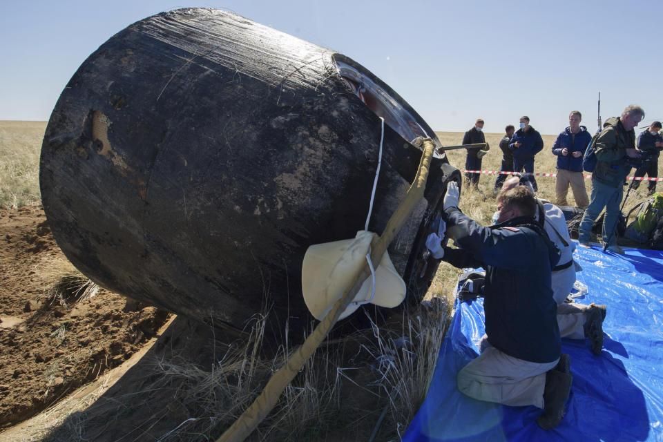 In this handout photo released by Gagarin Cosmonaut Training Centre (GCTC), Roscosmos space agency, rescue team members open the capsule hatch shortly after the landing of the Russian Soyuz MS-15 space capsule near Kazakh town of Dzhezkazgan, Kazakhstan, Friday, April 17, 2020. An International Space Station crew has landed safely after more than 200 days in space. The Soyuz capsule carrying NASA astronauts Andrew Morgan, Jessica Meir and Russian space agency Roscosmos' Oleg Skripochka touched down on Friday on the steppes of Kazakhstan. (Andrey Shelepin, Gagarin Cosmonaut Training Centre (GCTC), Roscosmos space agency, via AP)