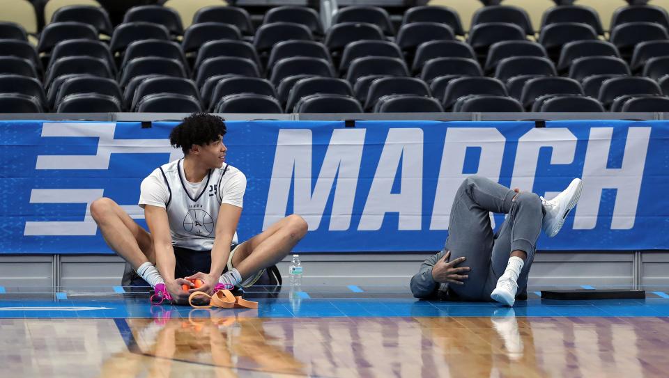 Akron's Enrique Freeman, left, warms up during an open practice Wednesday at PPG Paints Arena in preparation for the Zips' first-round NCAA Tournament game against Creighton on Thursday in Pittsburgh.