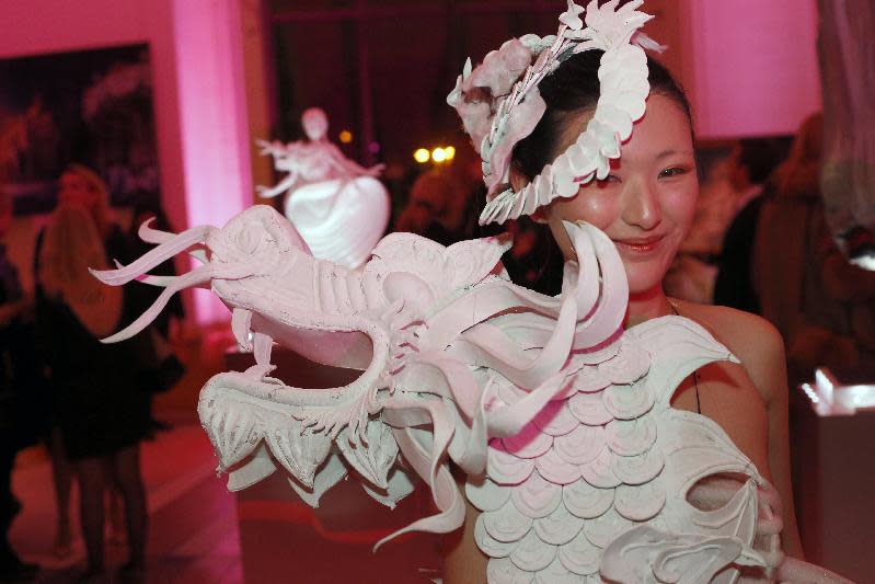 A Chinese model wears a creation designed by Xu Ming at the Petit Palais in Paris, Monday Nov. 25, 2013. The world's top fashion houses from Chanel, Prada and Christian Dior have brought together their needlework in a unique charitable venture: each designing children's dolls that will be sold at auction for UNICEF.(AP Photo/Francois Mori)