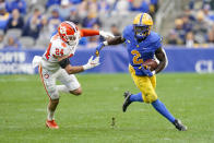 Pittsburgh running back Israel Abanikanda (2) gets away from Clemson safety Nolan Turner (24) on a run during the first half of an NCAA college football game, Saturday, Oct. 23, 2021, in Pittsburgh. (AP Photo/Keith Srakocic)