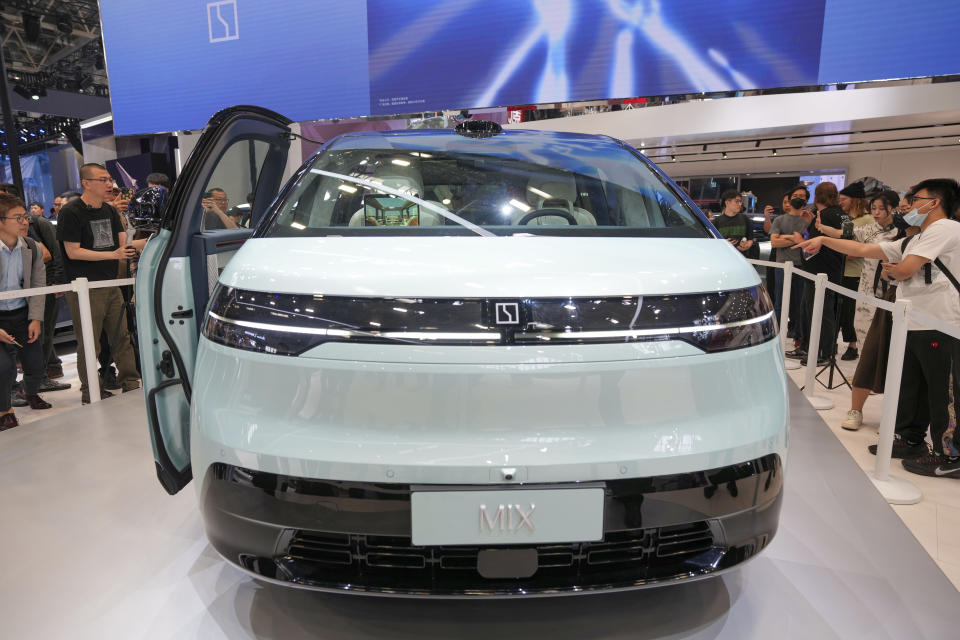 Visitors look at a Zeekr Mix car during the China Auto Show in Beijing, China, Friday, April 26, 2024. China's vision of the future of the automobile electrified and digitally connected is on display at the ongoing Beijing auto show. (AP Photo/Tatan Syuflana)