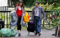 <p>A woman is helped with her belongings from the Burnham Tower, part of the Chalcots Estate in the borough of Camden, in London, Monday, June 26, 2017. The apartments were evacuated after fire inspectors concluded that the buildings were unsafe because of problematic fire doors, gas pipe insulation, and external cladding similar to that blamed for the rapid spread of a fire that engulfed Grenfell Tower on June 14. (Photo: Frank Augstein/AP) </p>