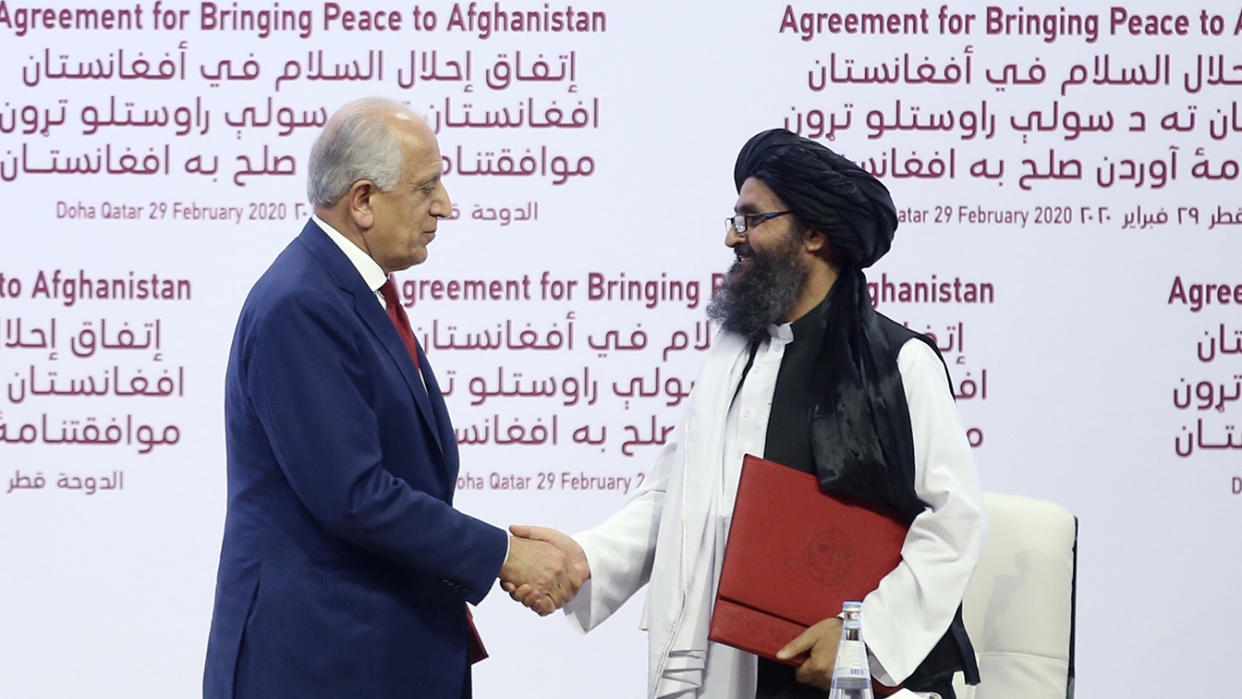 U.S. Special Representative for Afghanistan Reconciliation Zalmay Khalilzad (L) and Taliban co-founder Mullah Abdul Ghani Baradar (R) shake hands after signing the peace agreement between US, Taliban, in Doha, Qatar on February 29, 2020. (Fatih Aktas/Anadolu Agency via Getty Images)