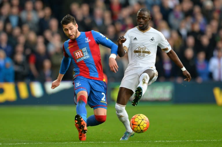 Crystal Palace's Joel Ward (L) fights for the ball with Swansea City's Modou Barrow during their English Premier League match, at Selhurst Park in south London, on December 28, 2015