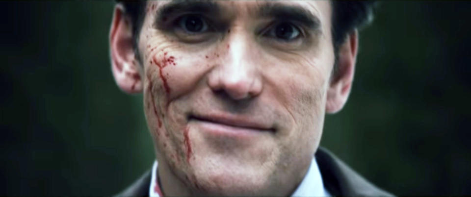 A man smiling with blood on his face