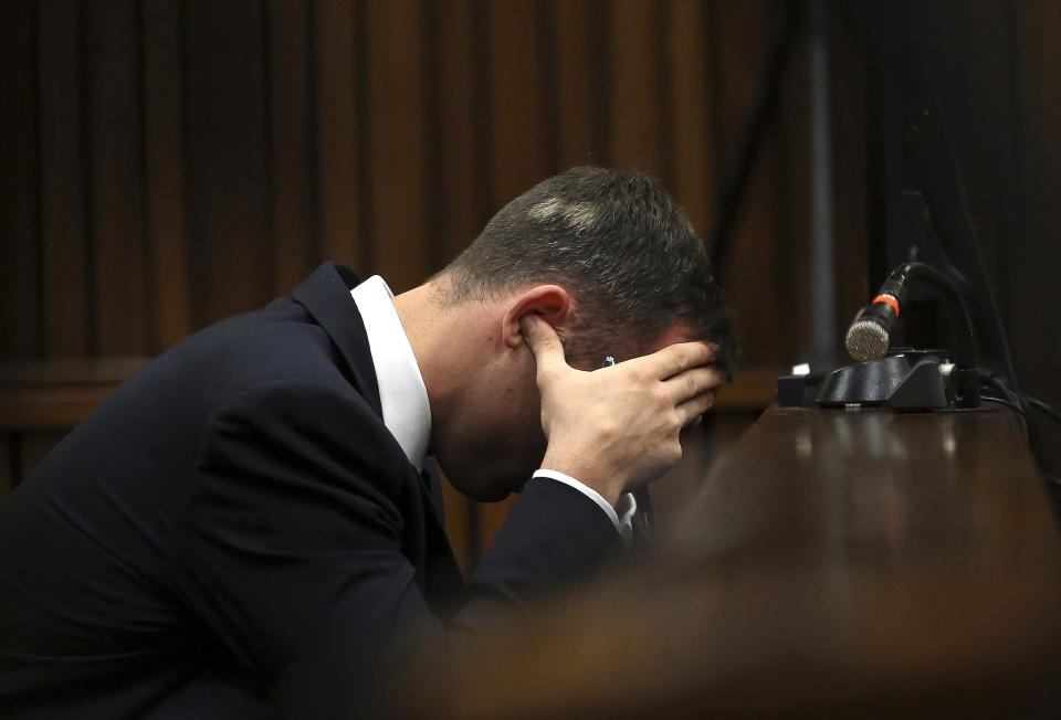 Oscar Pistorius, cradles his head in his hands as he listens to ballistic evidence being given in the court during his murder trial in Pretoria, South Africa, Wednesday, March 19, 2014. Pistorius is on trial for the murder of his girlfriend Reeva Steenkamp on Valentine's Day in 2013. (AP Photo/Themba Hadebe, Pool)