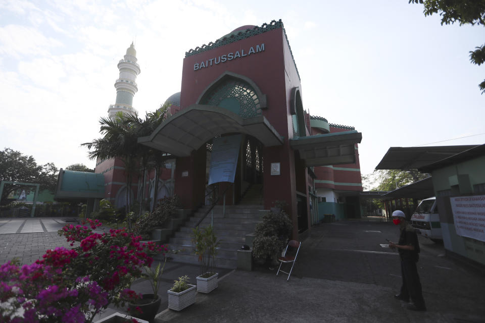 A man stands near an empty mosque in Jakarta, Indonesia, Tuesday, July, 20, 2021. Muslims across Indonesia marked a grim Eid al-Adha festival for a second year Tuesday as the country struggles to cope with a devastating new wave of coronavirus cases and the government has banned large gatherings and toughened travel restrictions. (AP Photo/Achmad Ibrahim)