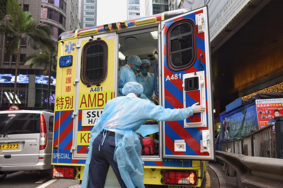 HONG KONG, CHINA - JANUARY 23: Health care members make first aid to people at an ambulance as they cover their faces with sanitary masks after the first cases of coronavirus have been confirmed in Hong Kong, China on January 23, 2020. On 22nd of January, China officially announced the Wuhan's virus outbreak can be transmitted human-to-human and implemented a public transportation and airport lockdown to slow down the spread of the virus. (Photo by Miguel Candela Poblacion/Anadolu Agency via Getty Images)