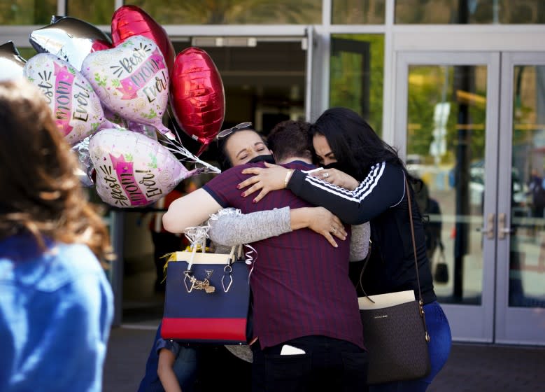 San Diego, CA - May 04: At the San Ysidro port of entry on Tuesday, May 4, 2021 in San Diego, CA., Sandra Ortiz, 48 exits from PedEast where she immediately is met with her son Bryan Chavez and Yeritzel Chavez. Ortiz was separated in San Diego from her son Bryan Chavez back in 2017 under the previous policy, and was soon there after deported back to Mexico. (Nelvin C. Cepeda / The San Diego Union-Tribune)