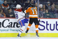 Philadelphia Flyers' Travis Konecny (11) and Montreal Canadiens' Marco Scandella (28) collide during the second period of an NHL hockey game, Thursday, Jan. 16, 2020, in Philadelphia. (AP Photo/Matt Slocum)