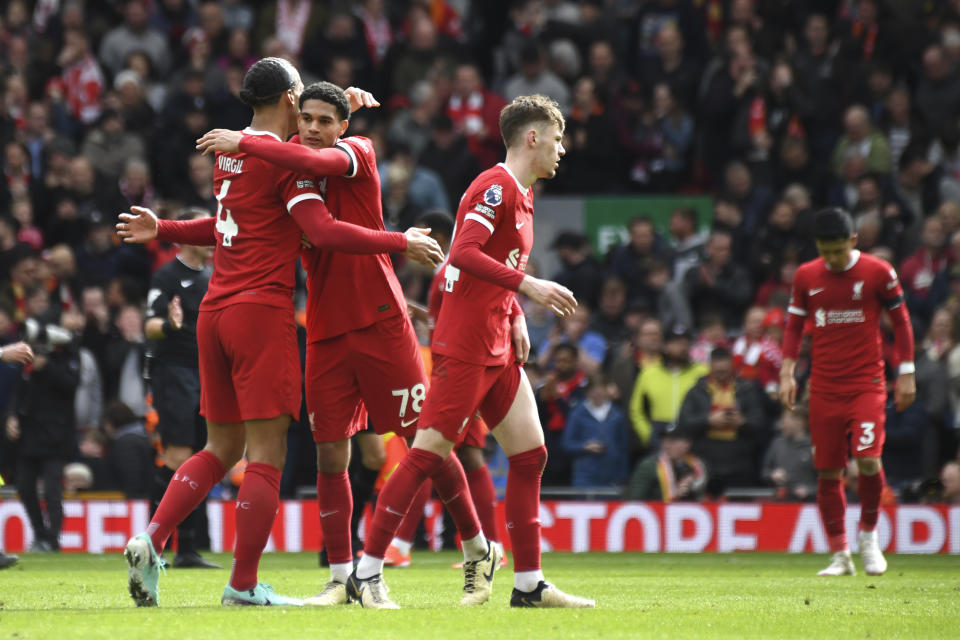 Liverpool's Virgil van Dijk, left, and Liverpool's Jarell Quansah celebrate their victory at the English Premier League soccer match between Liverpool and Brighton and Hove at Anfield Stadium in Liverpool, England, Sunday, March 31, 2024. (AP Photo/Rui Vieira)