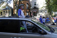 Chicago Cubs fans wait for a ball outside of Wrigley Field before the Opening Day baseball game between the Chicago Cubs and the Milwaukee Brewers in Chicago, Friday, July 24, 2020, in Chicago. In a normal year, that would mean a sellout crowd at Wrigley Field and jammed bars surrounding the famed ballpark. But in a pandemic-shortened season, it figures to be a different atmosphere. (AP Photo/Nam Y. Huh)