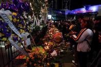 Fans of NBA basketball star Kobe Bryant pay their respects at a memorial outside the Staples Center at L.A. Live in Los Angeles